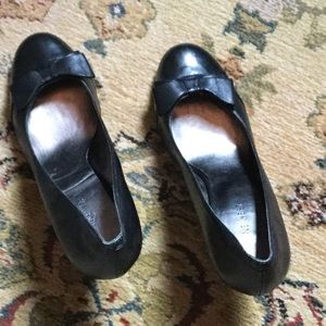 Black leather heels with bow detail